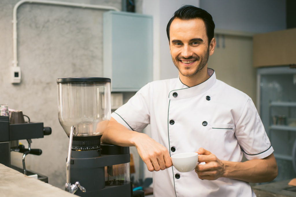 Chef standing in the kitchen smiling at the camera