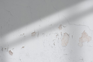 chipping paint on a kitchen wall because of water damage