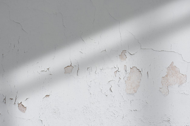 chipping paint on a kitchen wall because of water damage