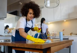 Professional cleaner wiping a table